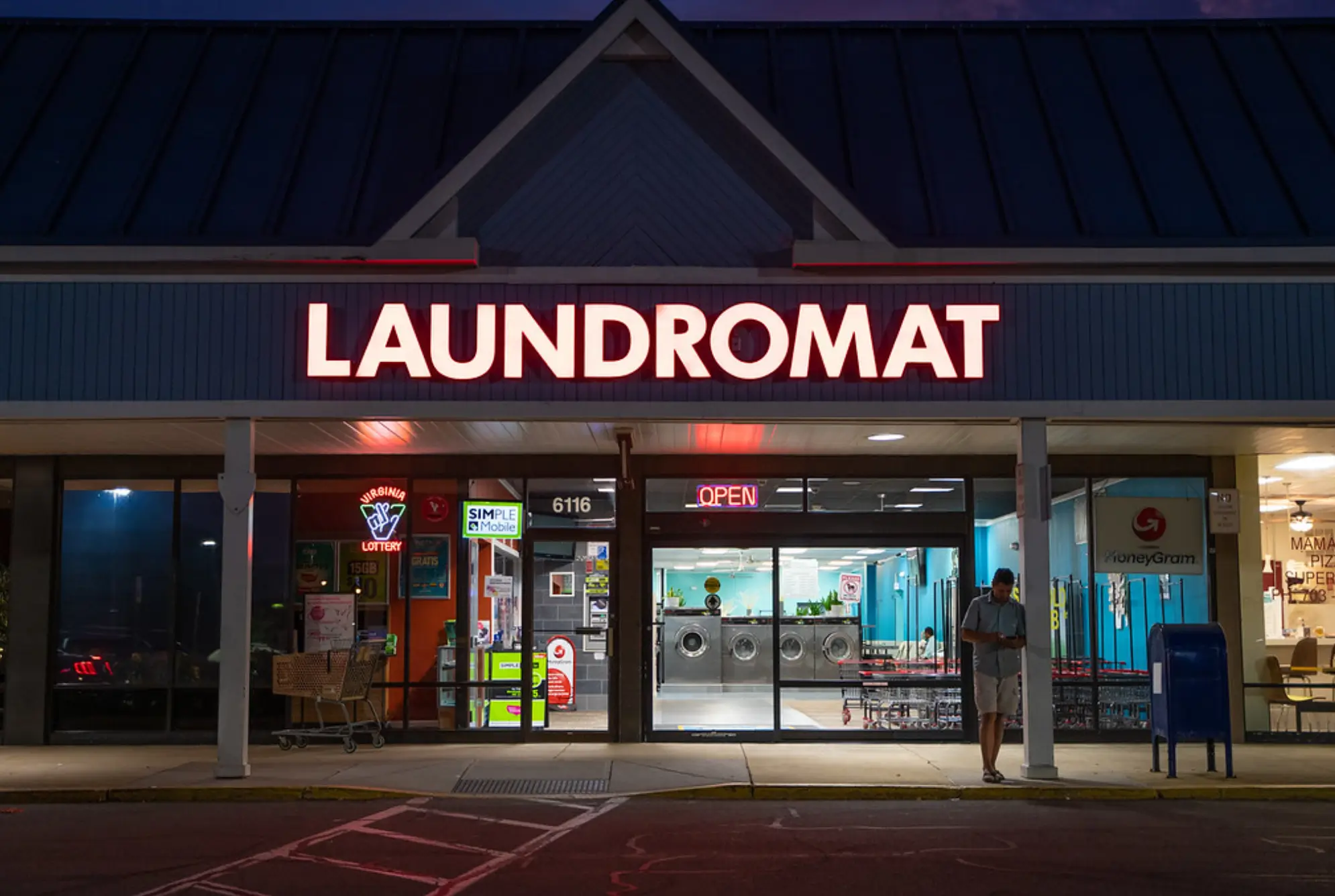 Nighttime exterior view of Rose Hill Wash self-service laundromat